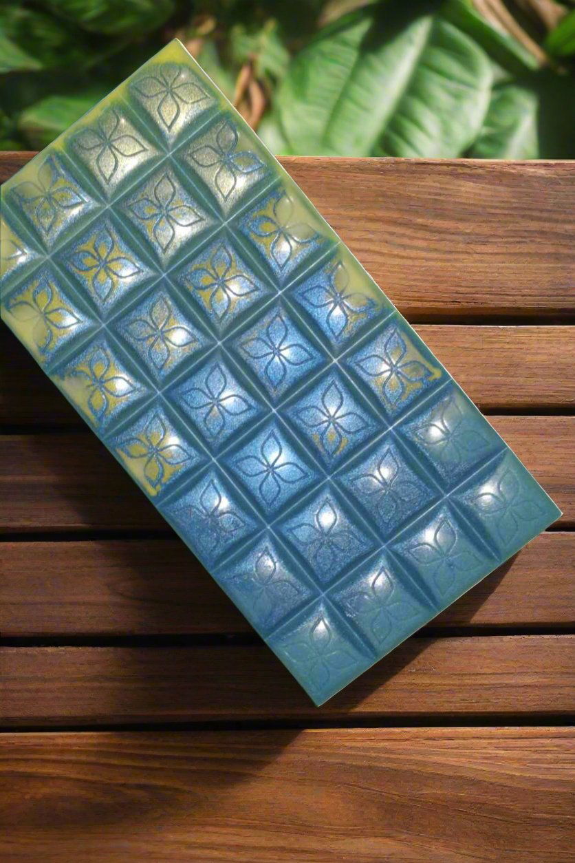 Blue wax melt with floral patterns on a wooden surface