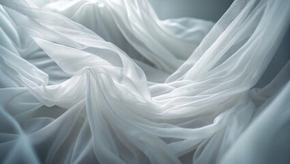 Close-up of white fabric with soft folds on a neutral background