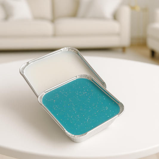 wax melts in tin container teal color on table with blurred living room background